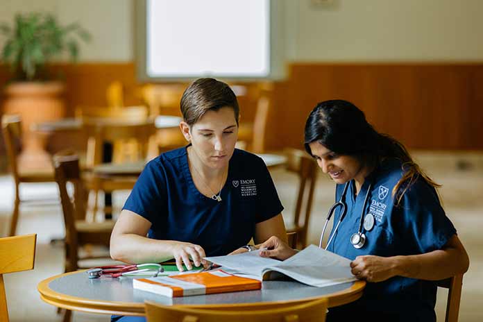 two nursing students studying at a table